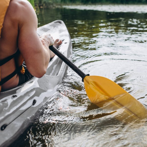 Young man kayaking on the river